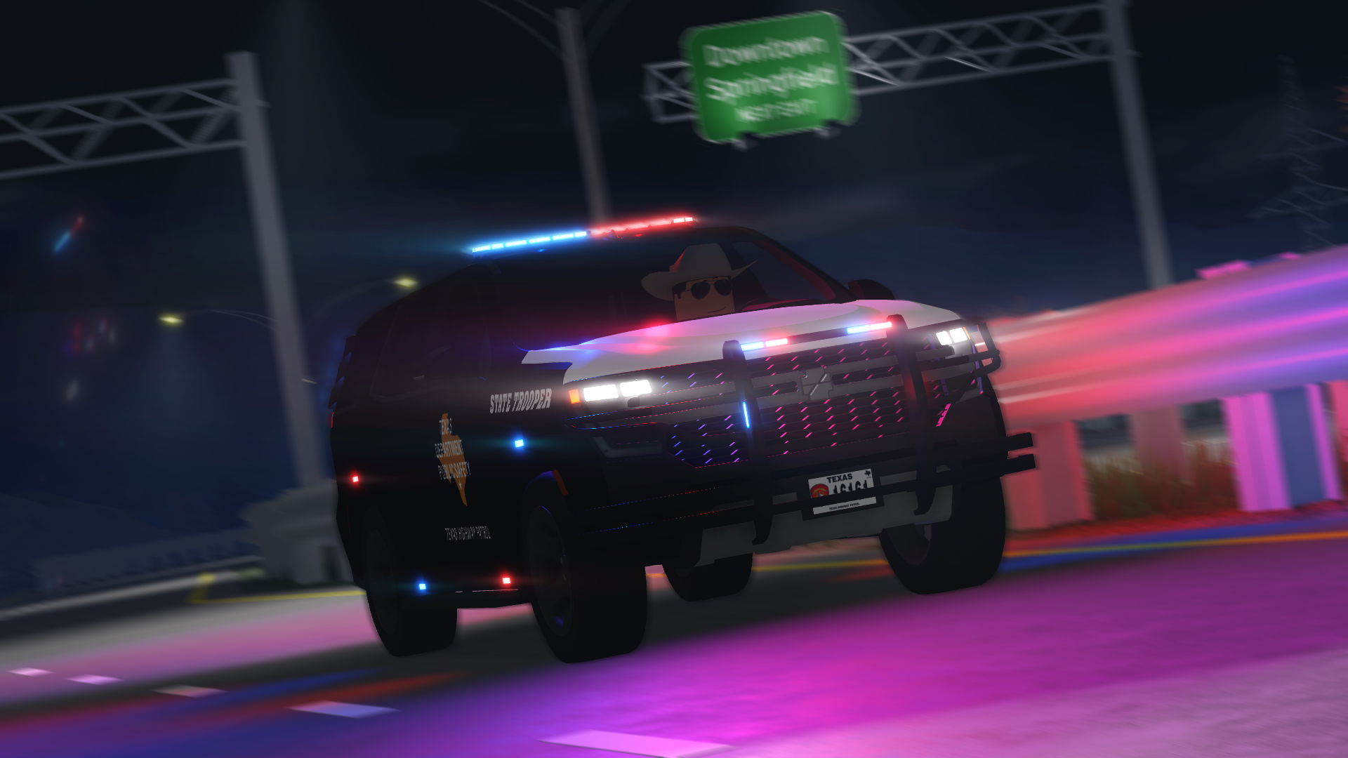 Texas DPS SUV driving at night with emergency lights illuminated.